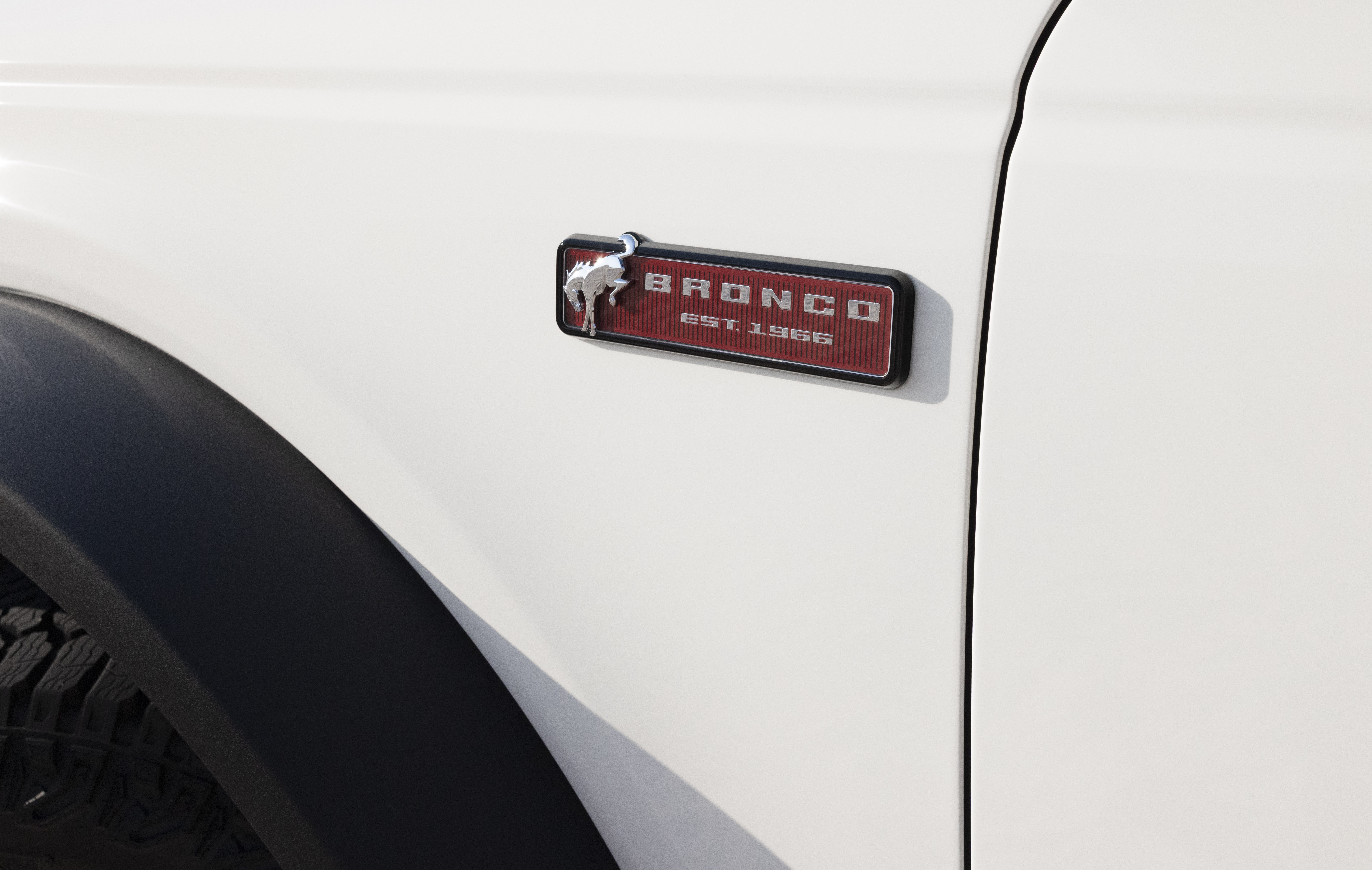 2026 Ford Bronco 60th Anniversary Package details shown. Small red plate near front tire reads "Bronco, 1966"